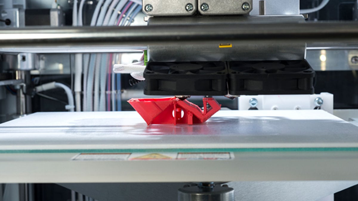 A Selective Laser Sintering (SLS) 3D printer in action.